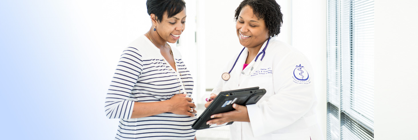 A pregnant woman looks at doctor's test results